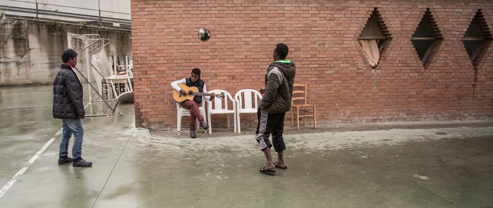 Young boys from Eritrea playing football and guitar