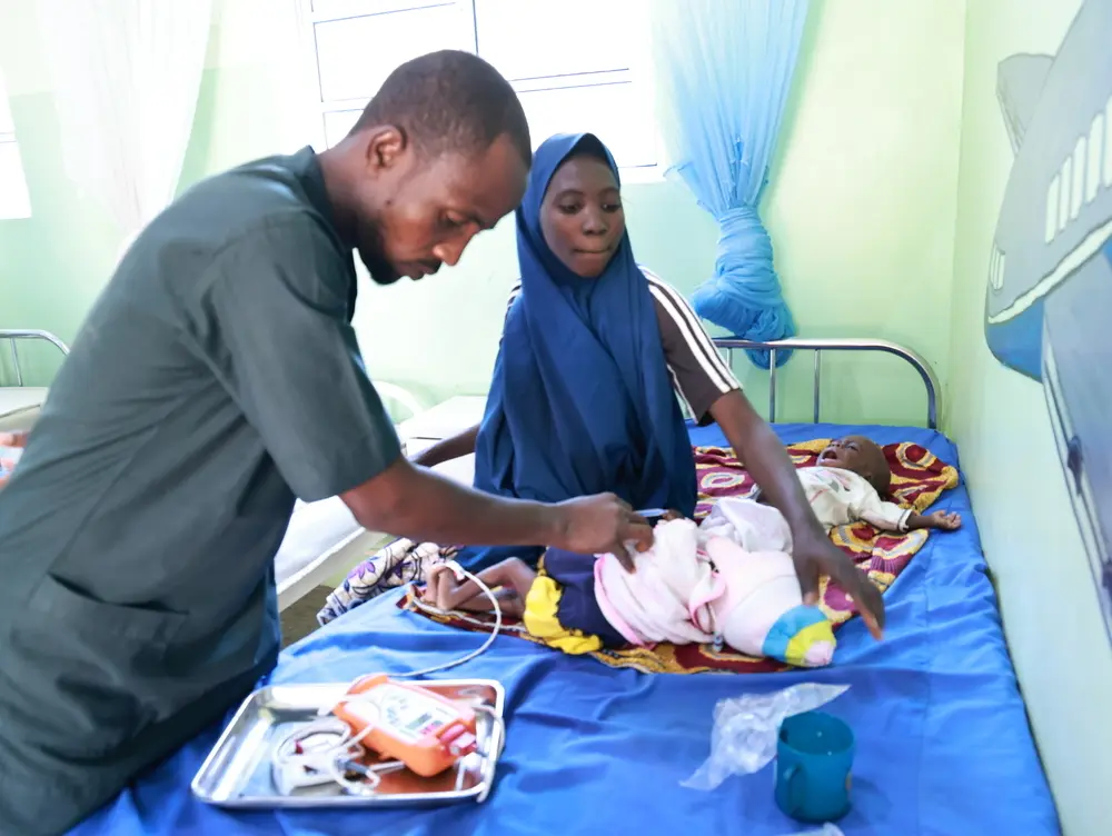 Un enfermero de MSF atendiendo a unos niños con malaria y desnutrición en Nigeria © Abdulkareem Yakubu