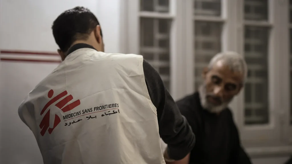 Dr Khaled Al-Shawwa is performing a minor surgery at the MSF clinic in Gaza City. Palestine, December 2024.
