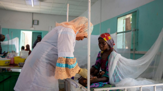 Una enfermera de MSF atiende a un niño con malaria, ante la mirada de su madre, en la unidad pediátrica del hospital Magaria de MSF en Magaria, Níger.