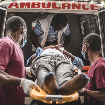 Un paciente siendo subido a una ambulancia de MSF en Turgeau, Haití