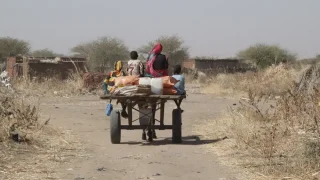 Una familia regresa a casa tras recibir canastas de alimentos en una distribución en Darfur Sur. Sudán, enero de 2025.