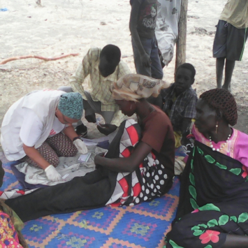 An MSF medic provides care to an IDP