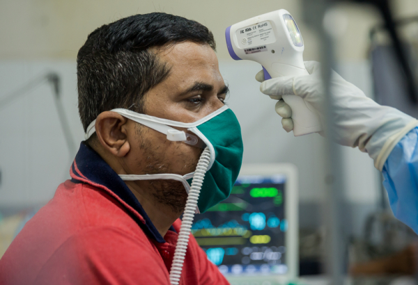 Patient Pramod getting his temperature checked at the HFNC.jpg